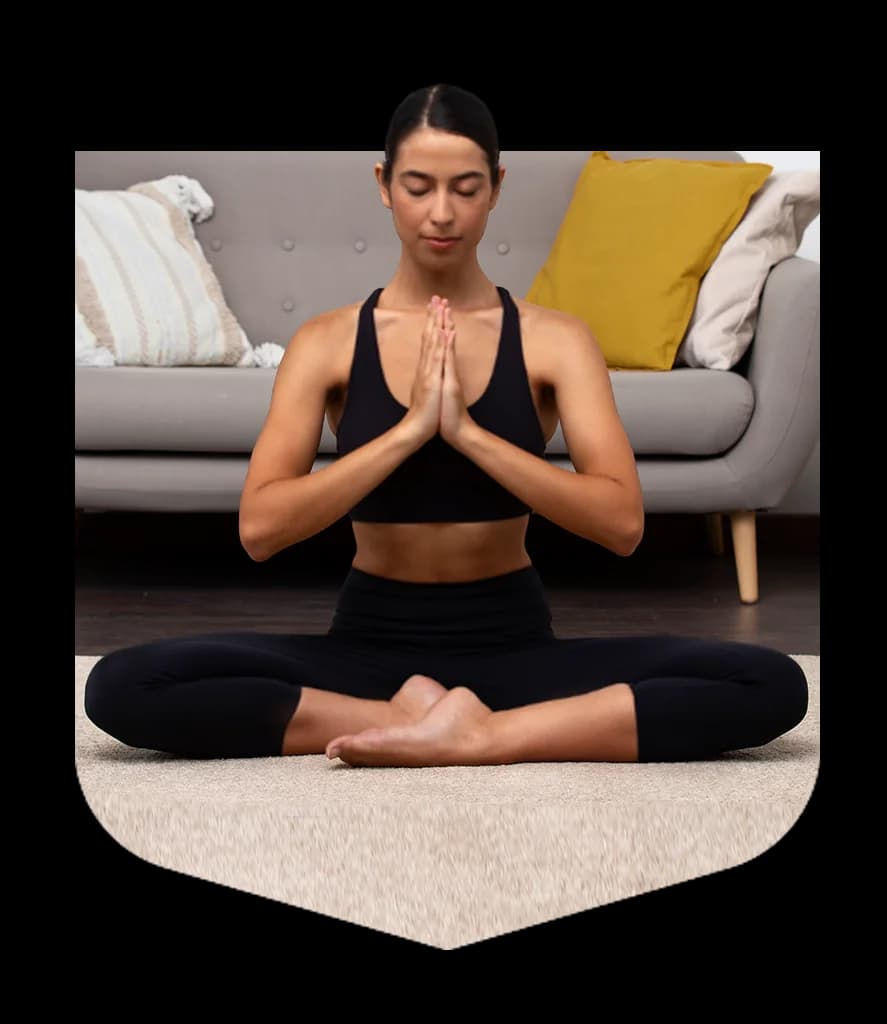 Woman meditating cross-legged with her palms pressed together
