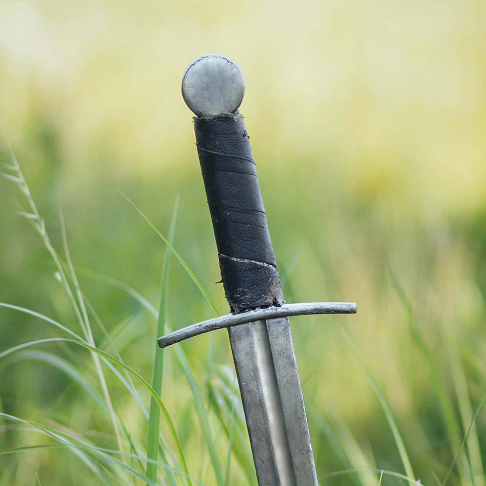 Sword stuck in the ground of a field
