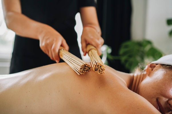 Woman receiving bamboo massage.