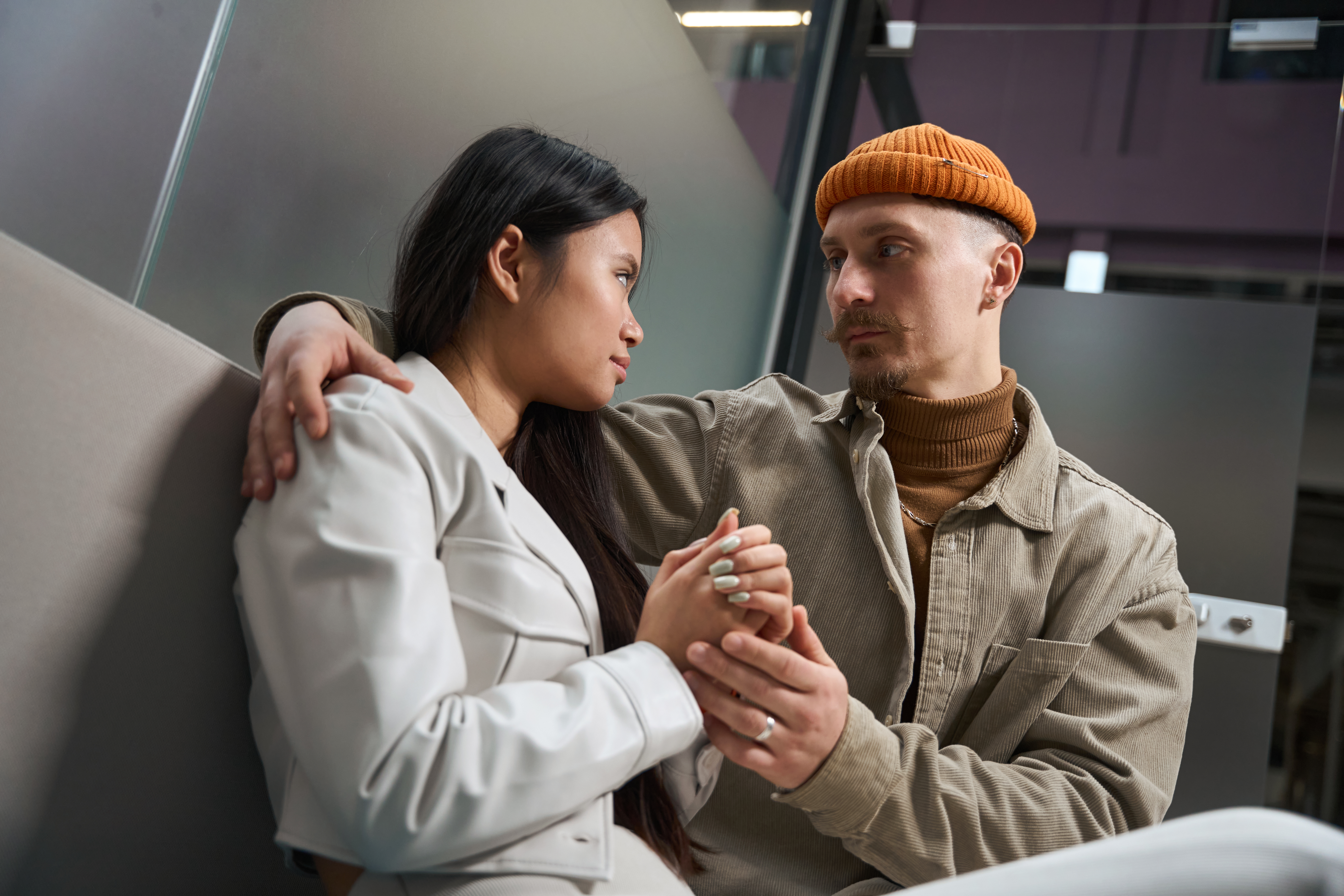 A couple holding hands looking at each other