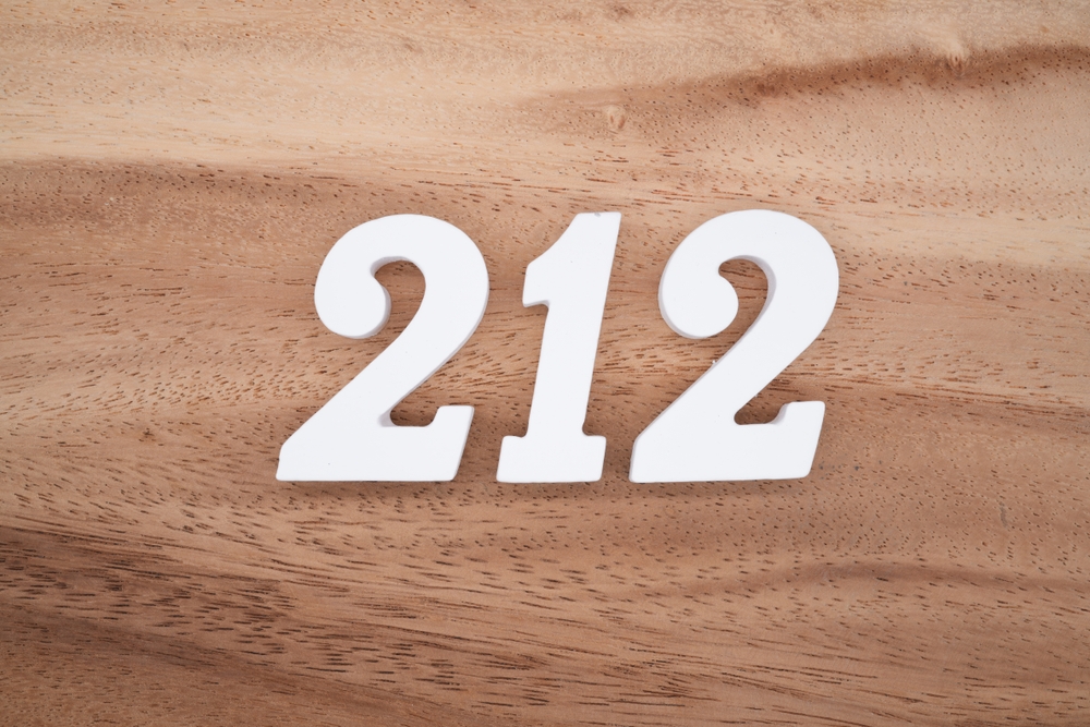 212 written in white numbers on a wooden background