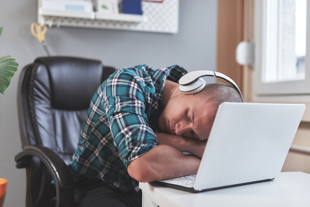 A man asleep at a desk