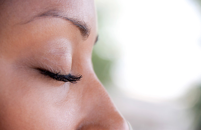 Close up of someone with their eyes closed meditating