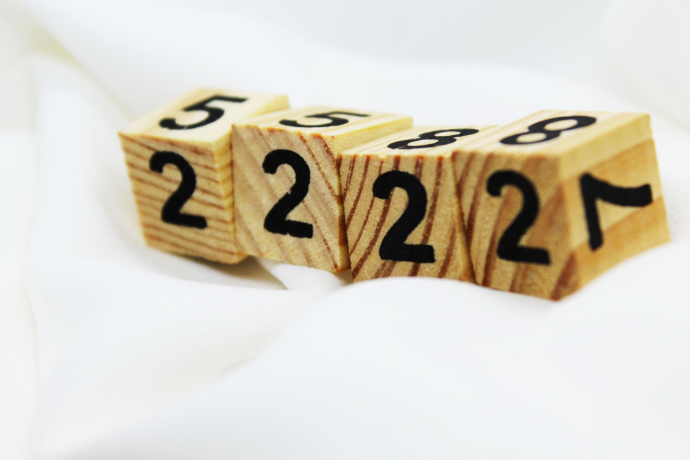 Four wooden blocks with the number two written on each one