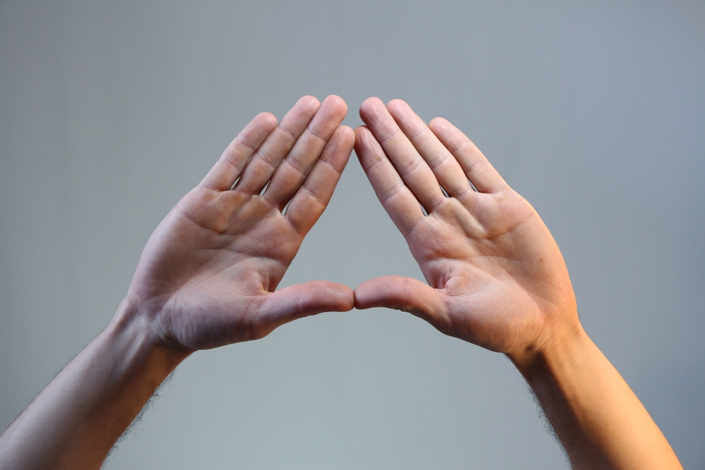 Two hands making a triangle