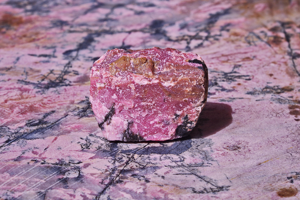 A raw piece of Rhodonite