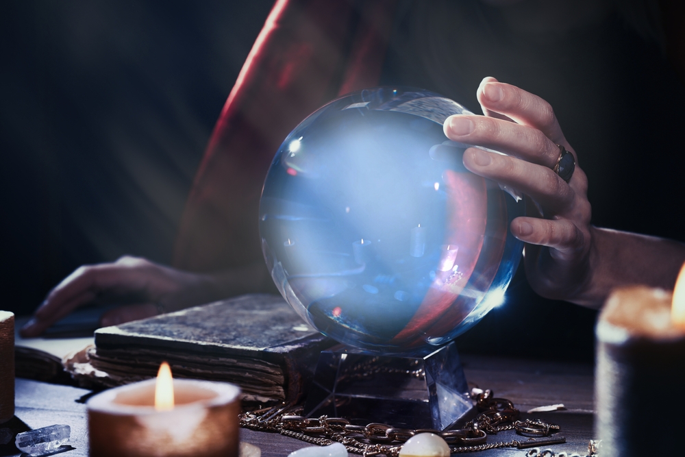 Someone using a crystal ball for a psychic  reading