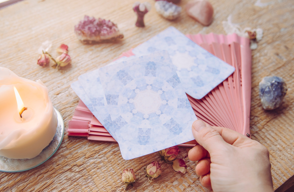 An image of oracle cards in someone's hand